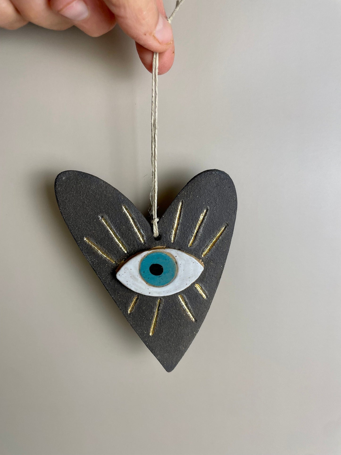 Handmade ceramic heart with evil eye charm