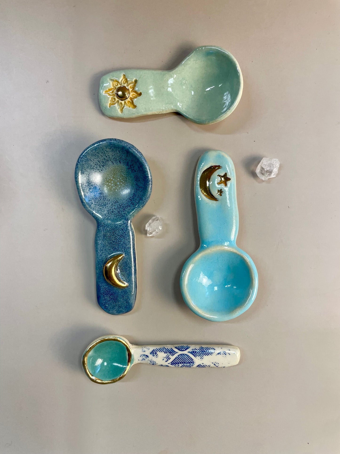 Handmade ceramic aqua and blue leaf spoon with gold luster rim.
