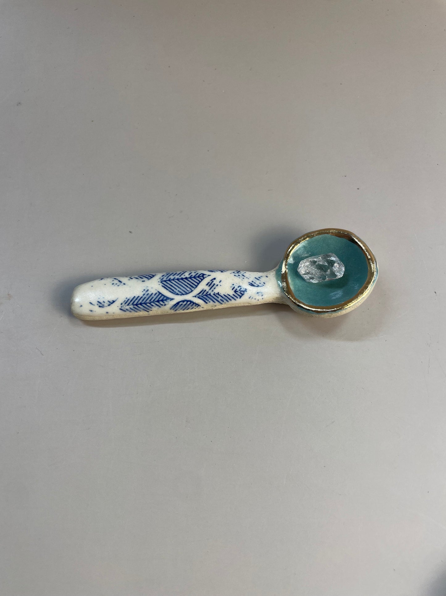 Handmade ceramic aqua and blue leaf spoon with gold luster rim.