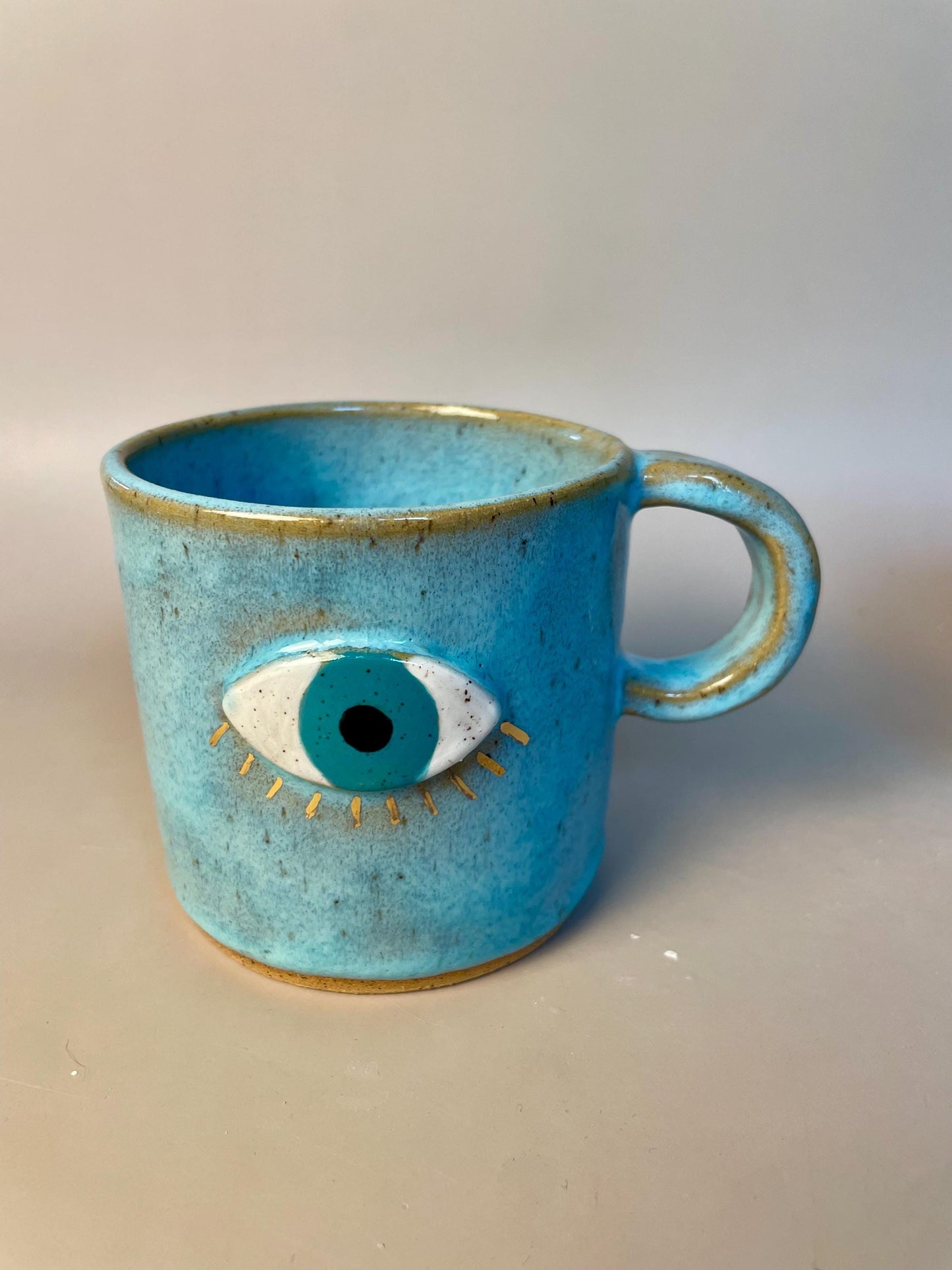 Handmade ceramic aqua evil eye mug with gold luster