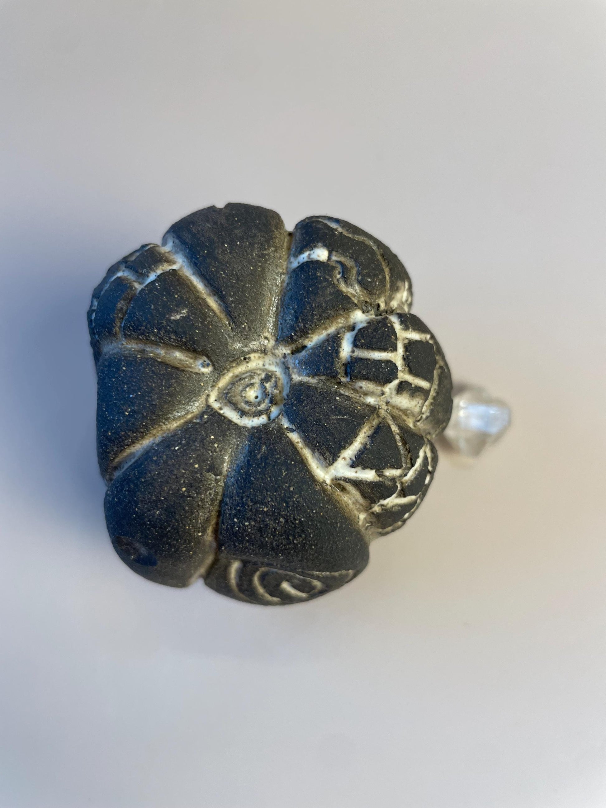 Handmade ceramic carved clay rattle with spiral and eye symbols