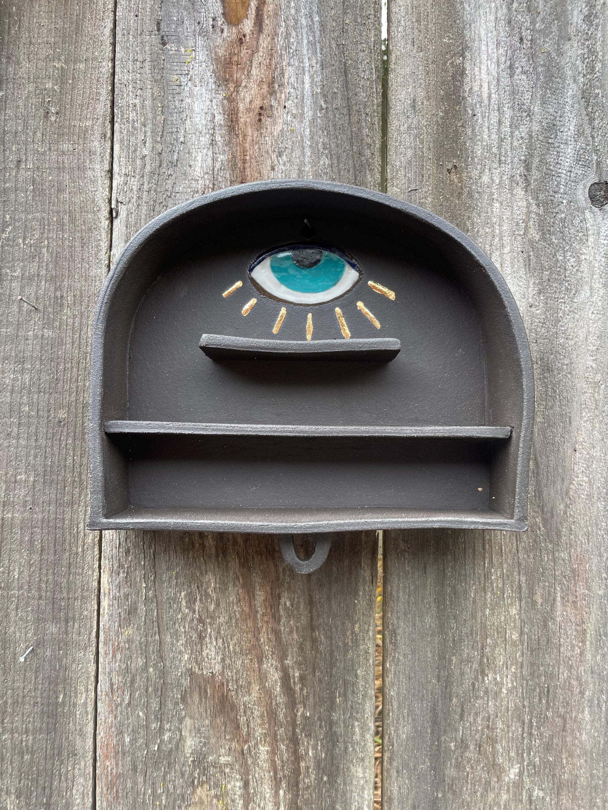 Handmade altar shelf with evil eye and gold rays