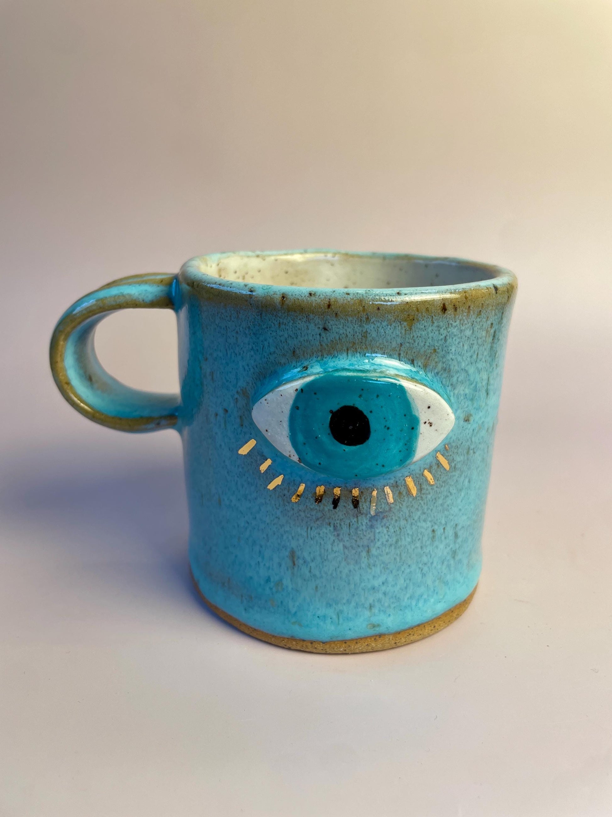 Aqua Eye Mug with Gold Luster Rays – Hand-Built Ceramic Cup | Honey Clay Mug with All-Seeing Eye | Symbolic Artisan Pottery